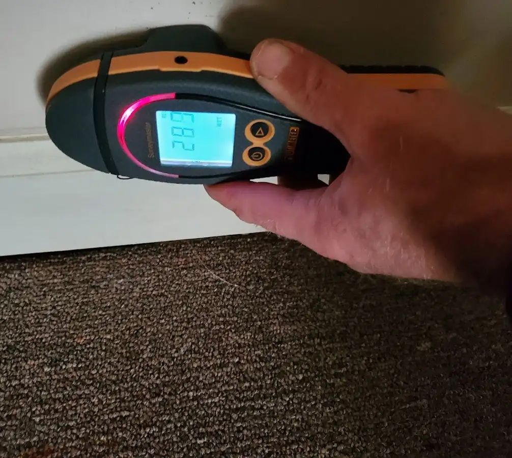 Moisture detection at baseboard during Storm Damage Restoration in Fairview Shores